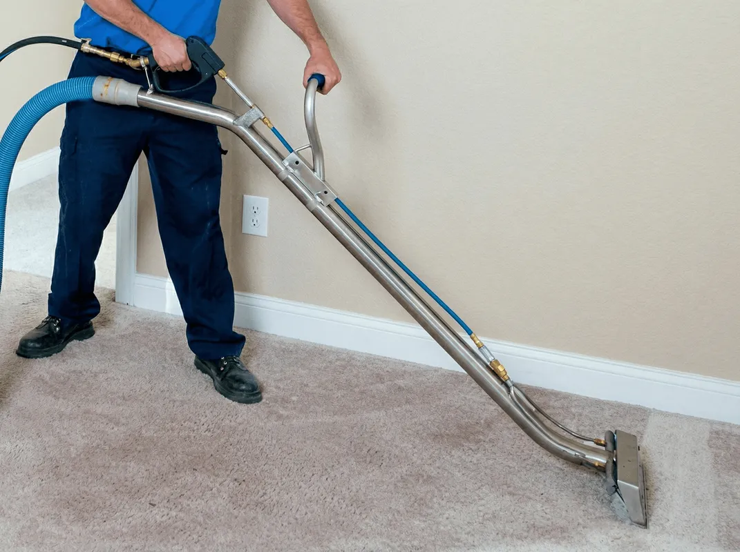 Professional operating a liquid removal machine on a carpeted floor in Cape Coral, FL